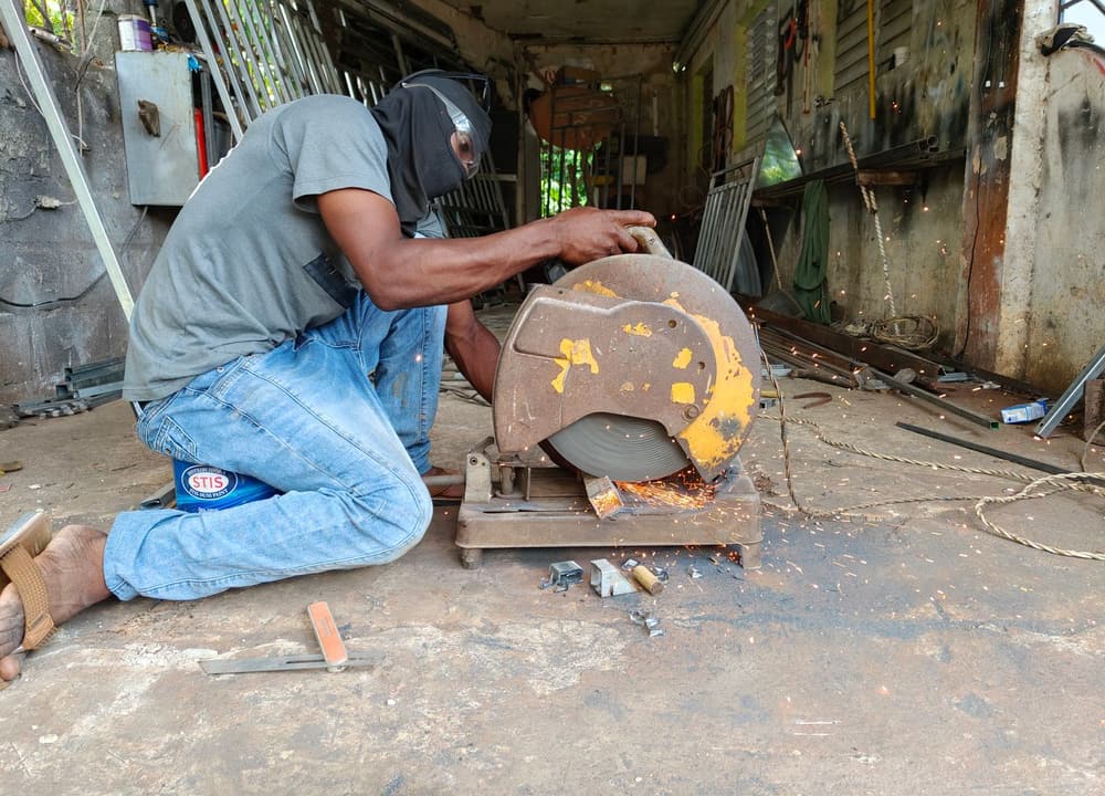 A craftsman working an angle grinder alone in a workshop